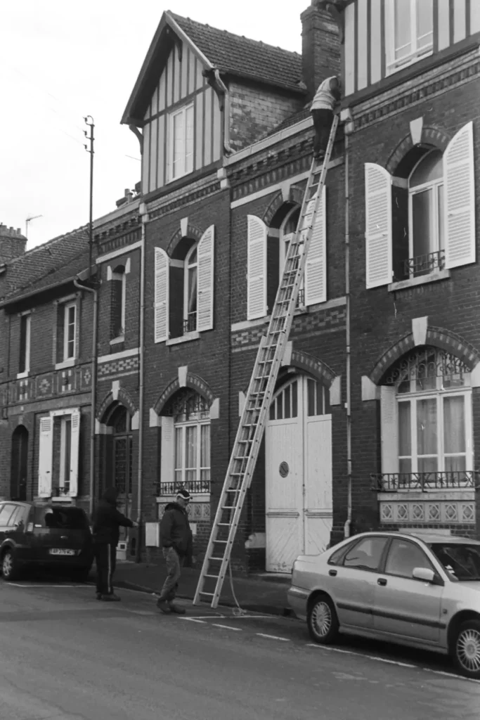 Ladder set up against a house for work along the roofline
