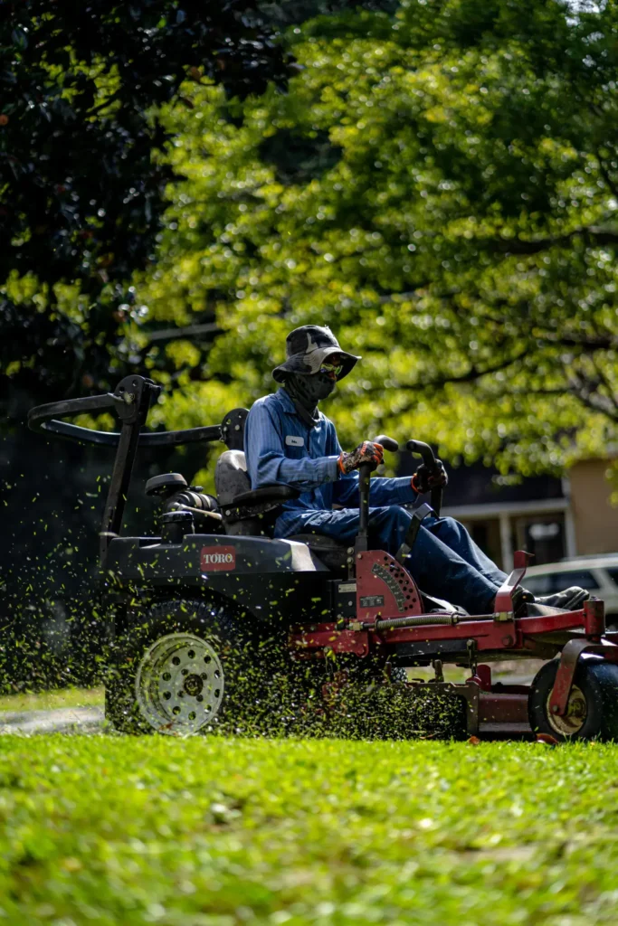 Riding mower working across a large open grass area
