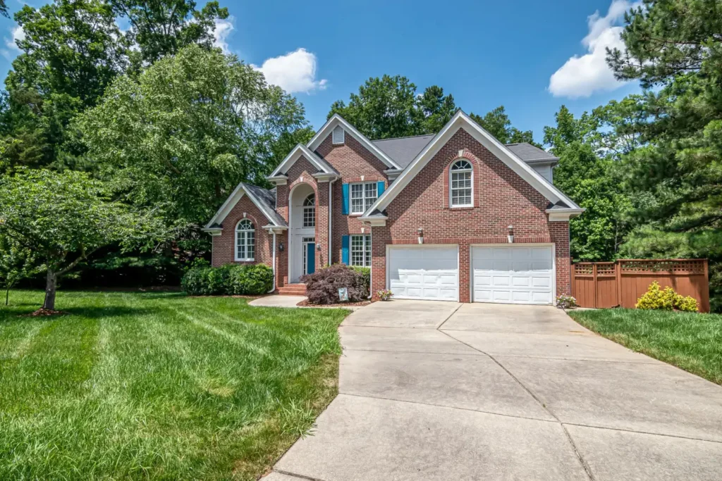 Brick house with a double garage and well-kept green surroundings