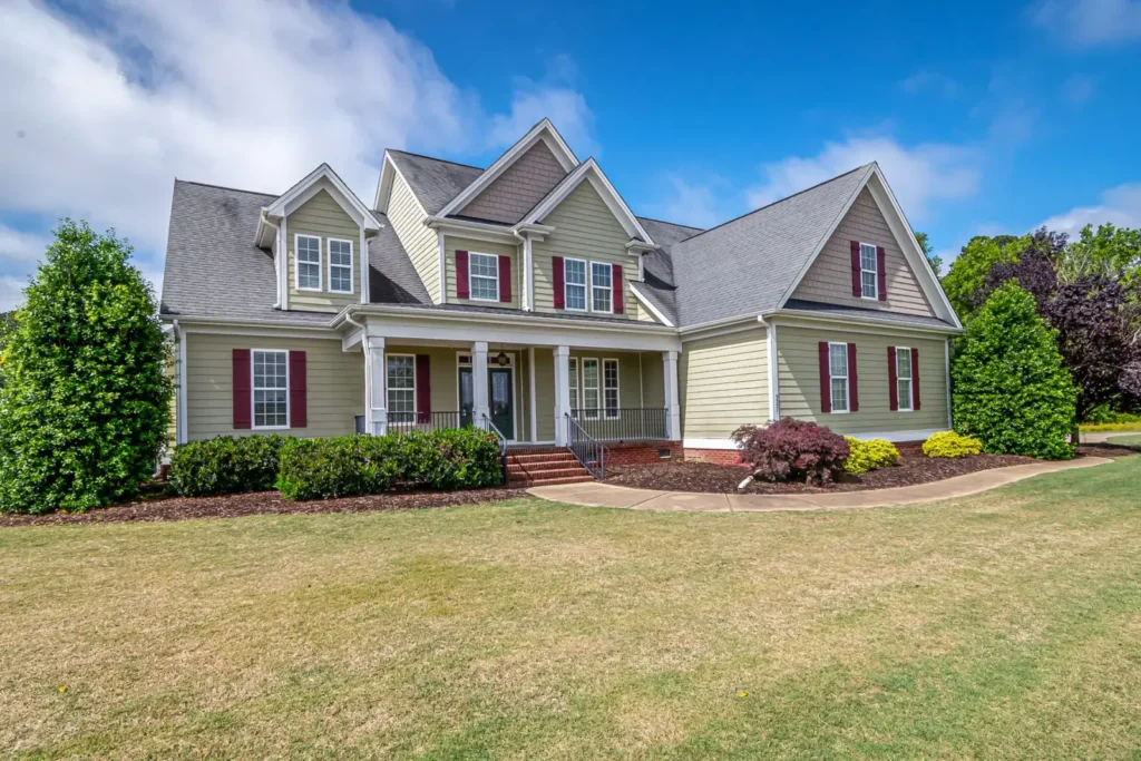 Suburban house with a well-maintained lawn under a clear sky